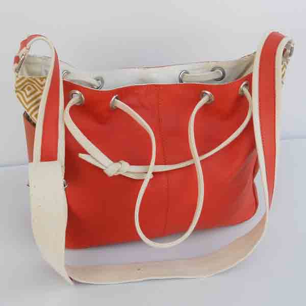 Red color leather purse with red natural cotton canvas handles .