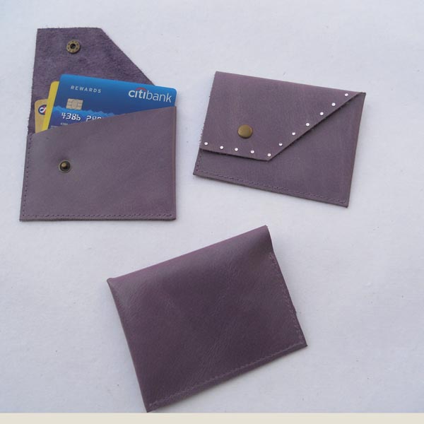 Blue color leather credit card holder with gem stones glued .