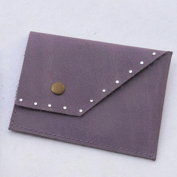 Blue color leather credit card holder with gem stones glued .