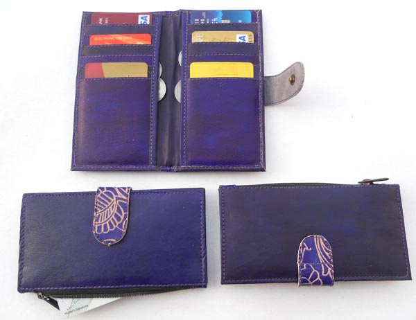 Blue leather with multiple pockets for credit cards & two large side pockets.