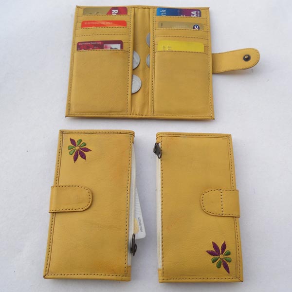 Pale yellow leather with multiple pockets for credit cards & two large side pockets for coins / documents