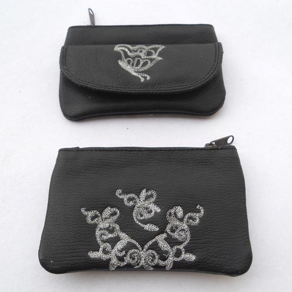 Black leather with silver color embroidery on the front & back.
