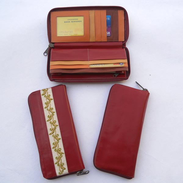 Maroon color leather with multiple pockets inside in multiple color leather.