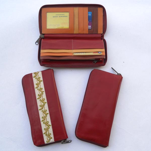 Maroon color leather with multiple pockets inside in multiple color leather.