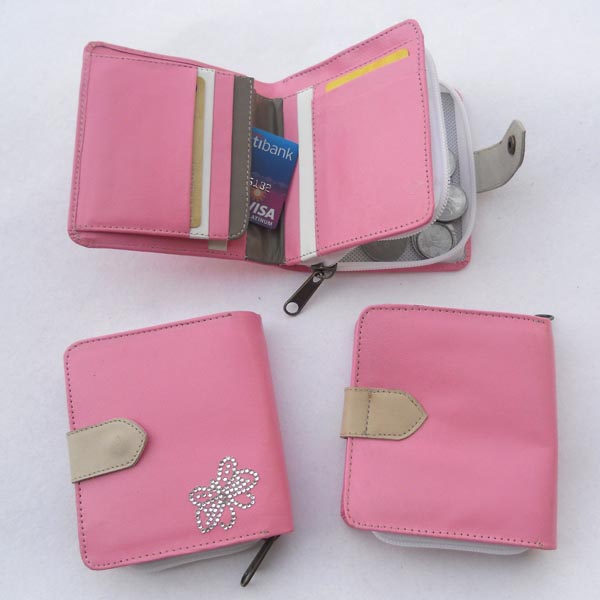 Pink leather wallet with multiple pockets outside a grey leather stripe for the closure.