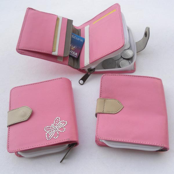 Pink leather wallet with multiple pockets outside a grey leather stripe for the closure.