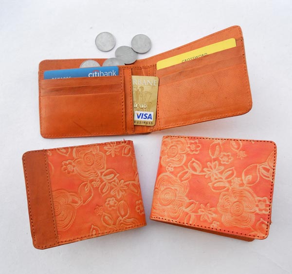 Beige faded carved leather with & light orange leather with multiple pockets inside for multiple uses.