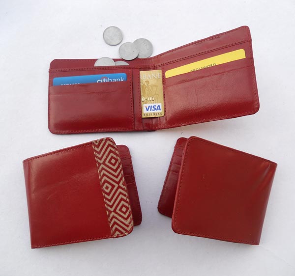 Red and printed red leather with multiple pockets inside for multiple uses.