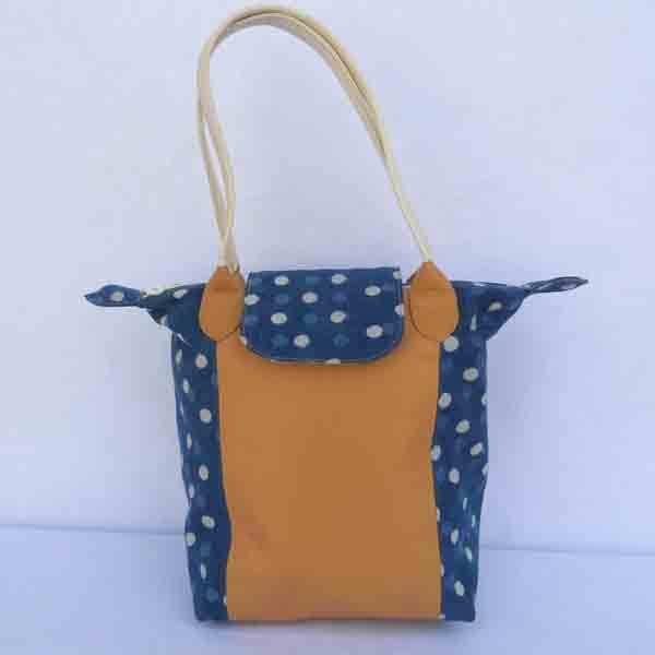 Light brown leather purse with batik printed cotton canvas in two colors.
