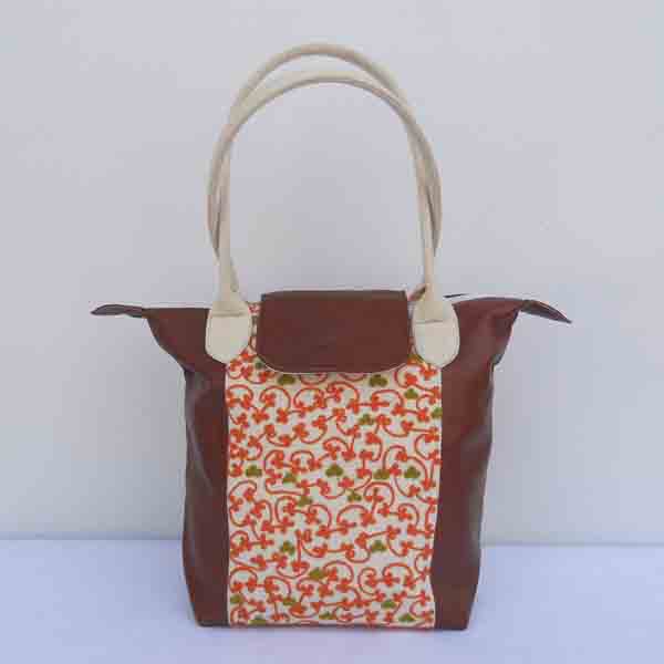 Dark brown leather purse with embroidered cotton canvas handle is of natural canvas too.