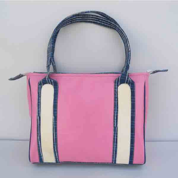 Pink leather purse with white leather stripes and indigo blue batik printed canvas handles & bottom.